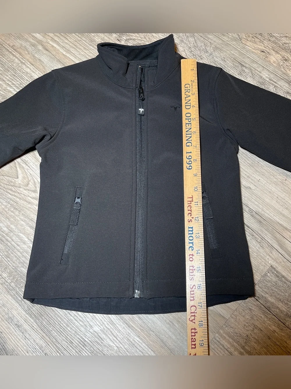 TESLA -The image features a Tesla Kids Corporate Softshell Jacket, black